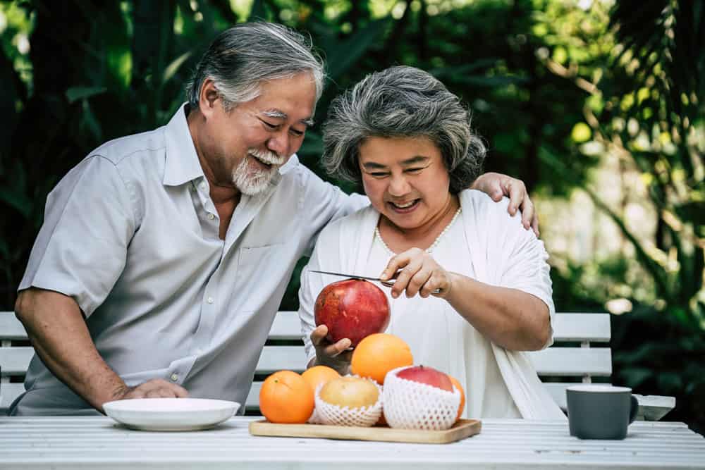 elderly-couples-playing-eating-some-fruit