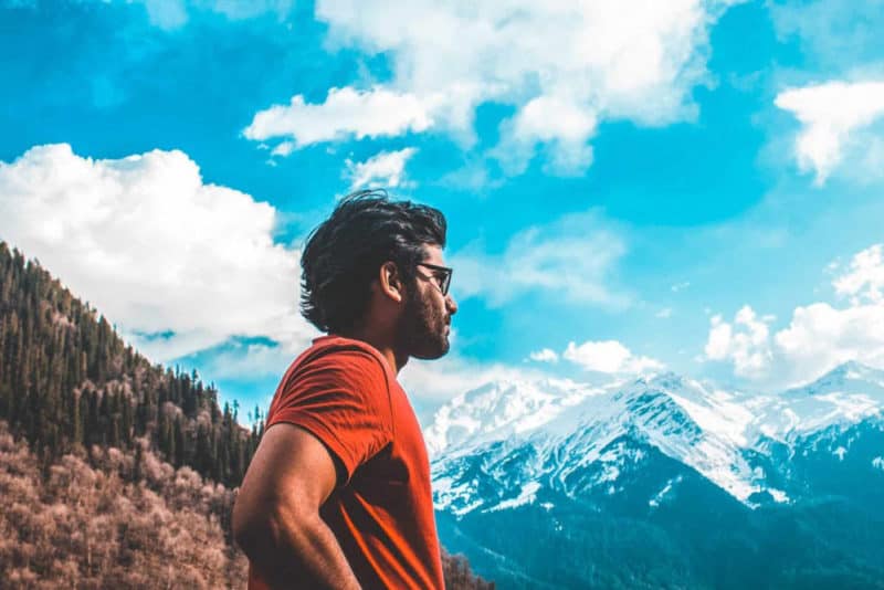Man looking at mountains with sunglasses