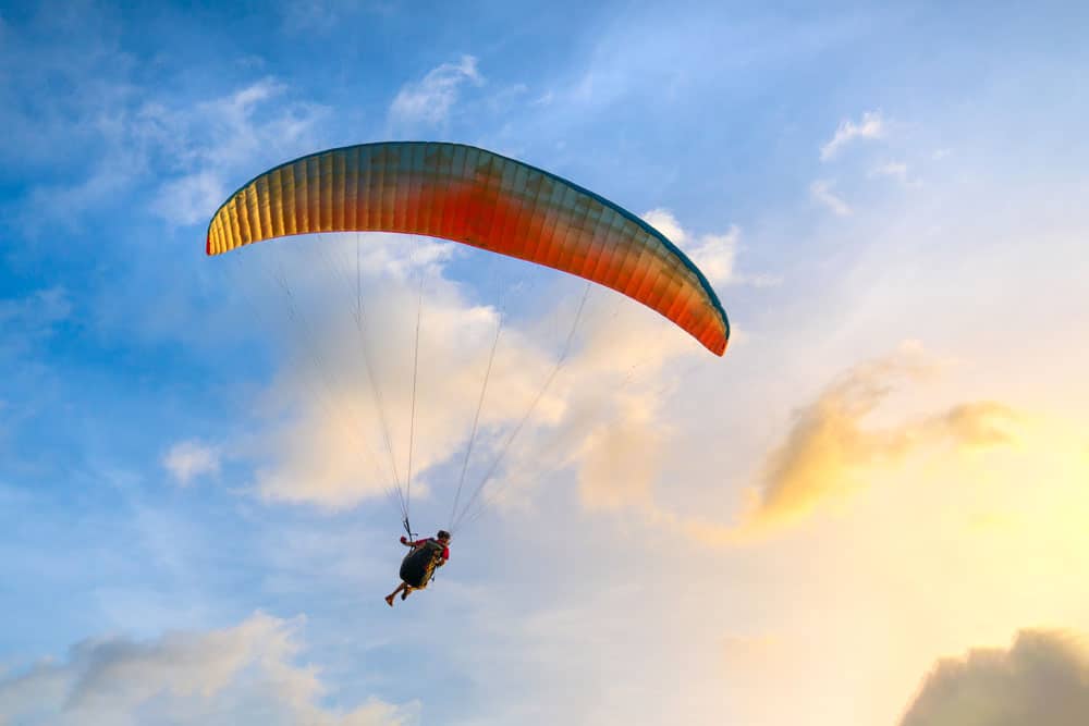 paraglider-soaring-blue-sky