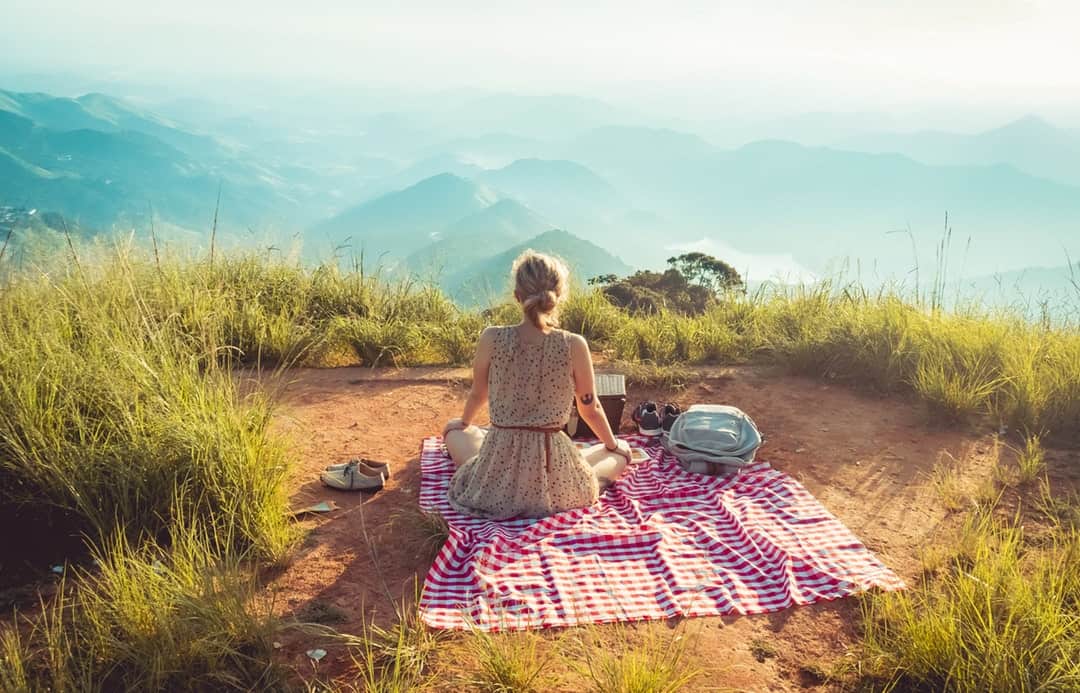 Woman having picnic in hills