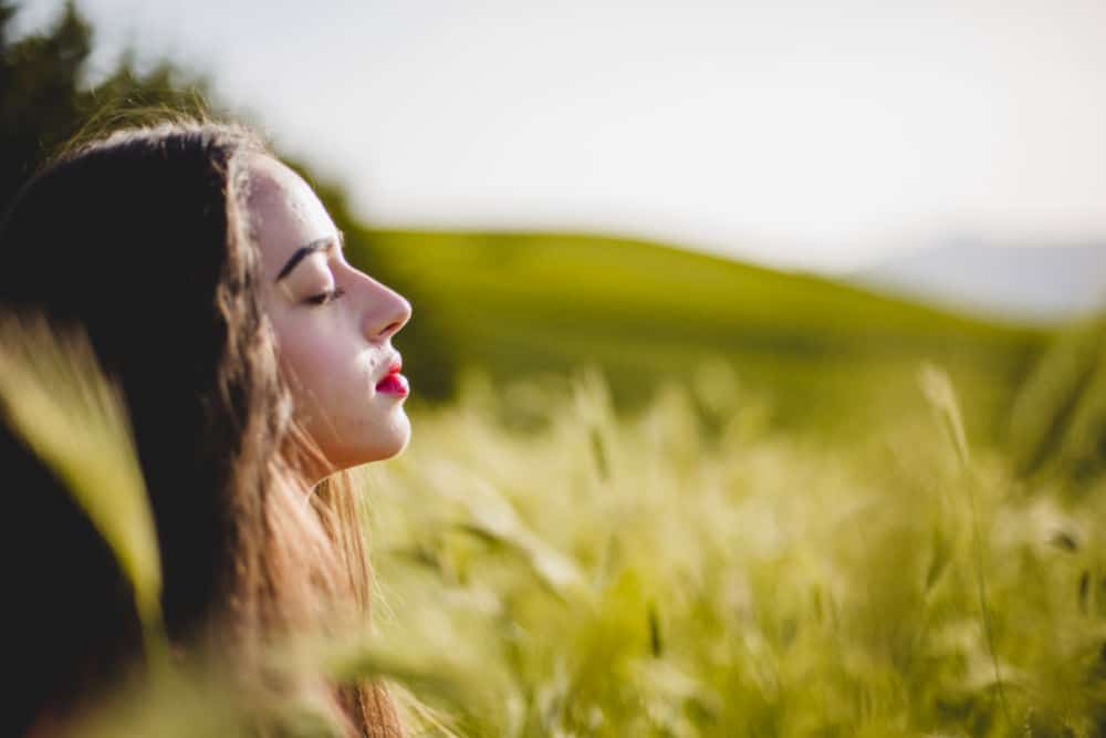 woman meditating in field