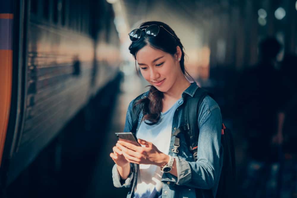 Asian woman traveling with mobile phone