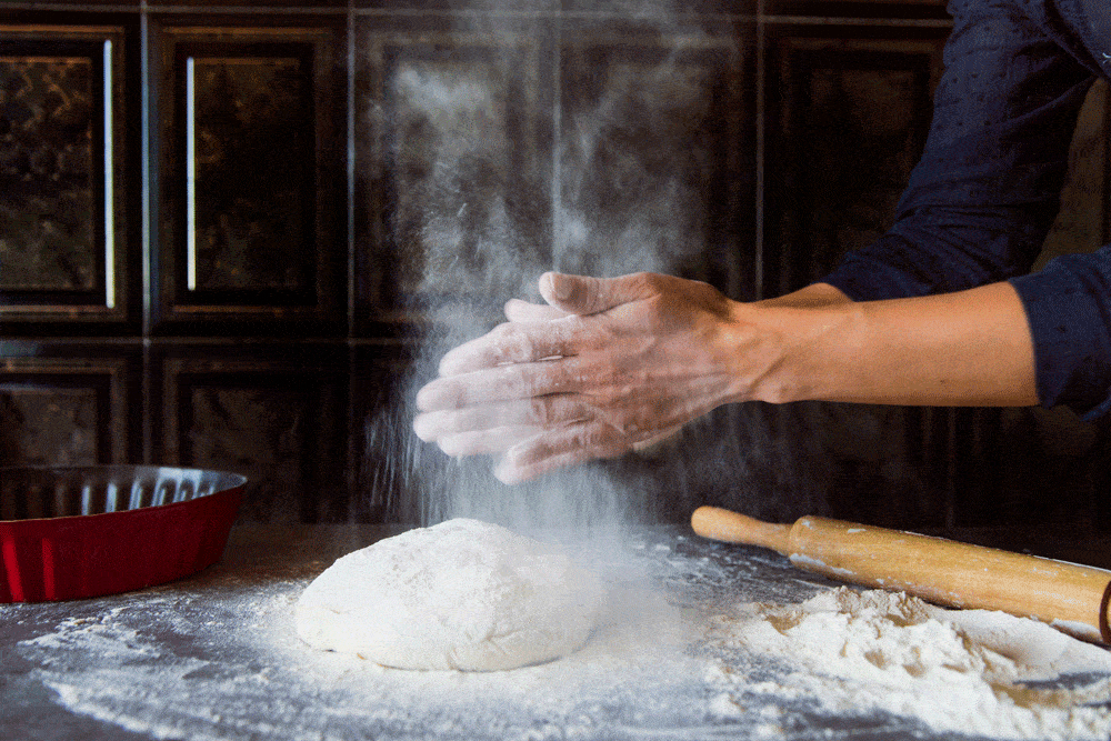 kneading dough on kitchen-bench