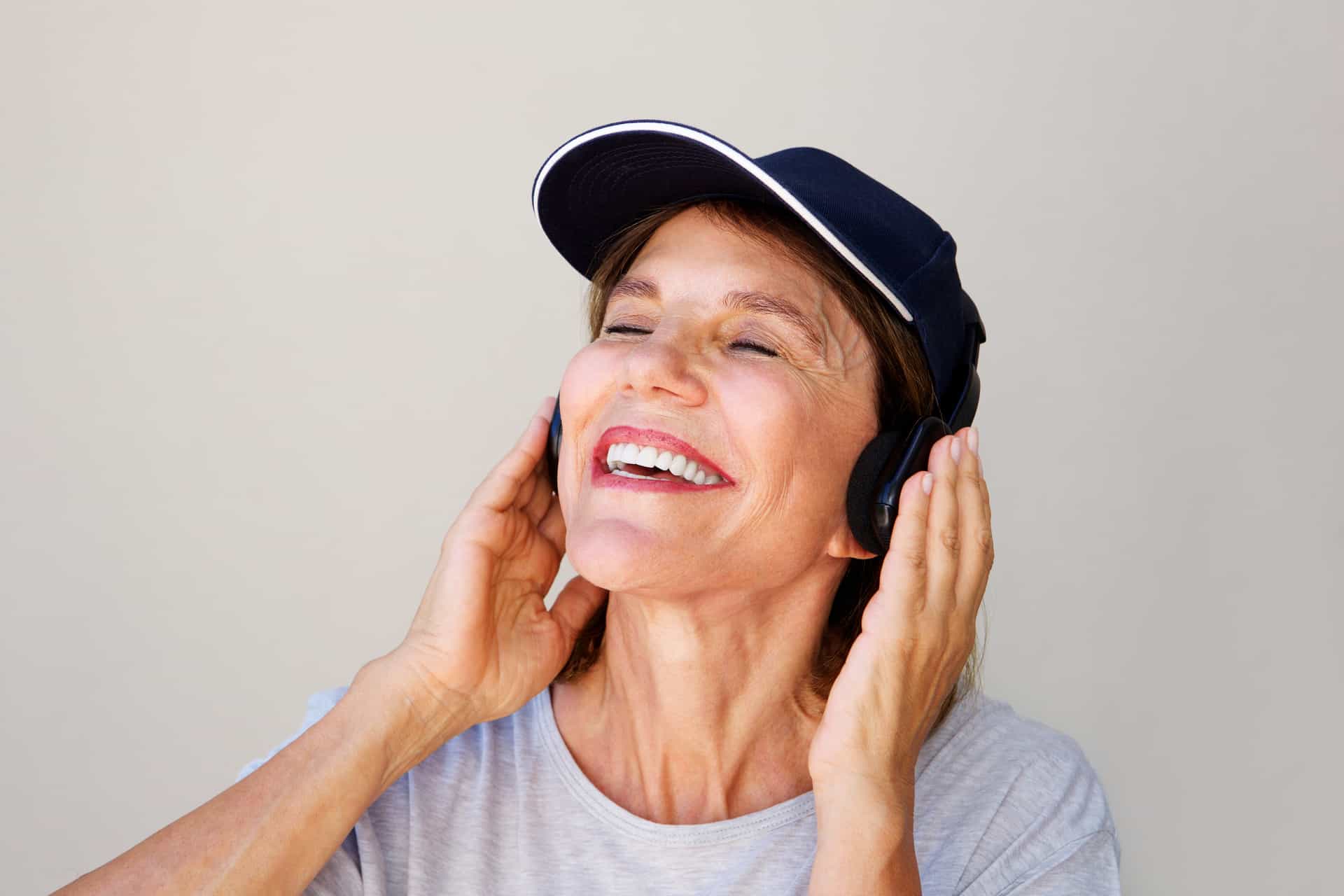 Portrait of older woman enjoying music on headphones