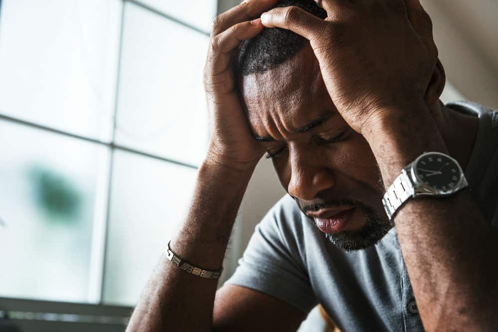 man-stressting-headache-fatigue