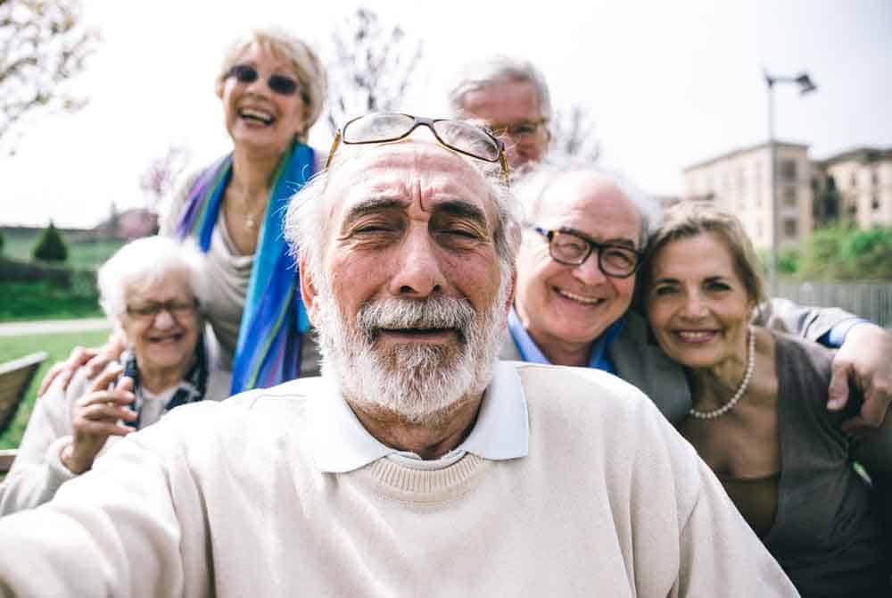 group of seniors taking selfie