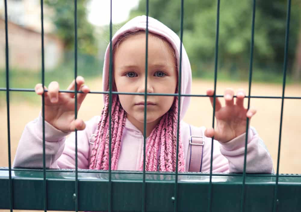child-behind-fence