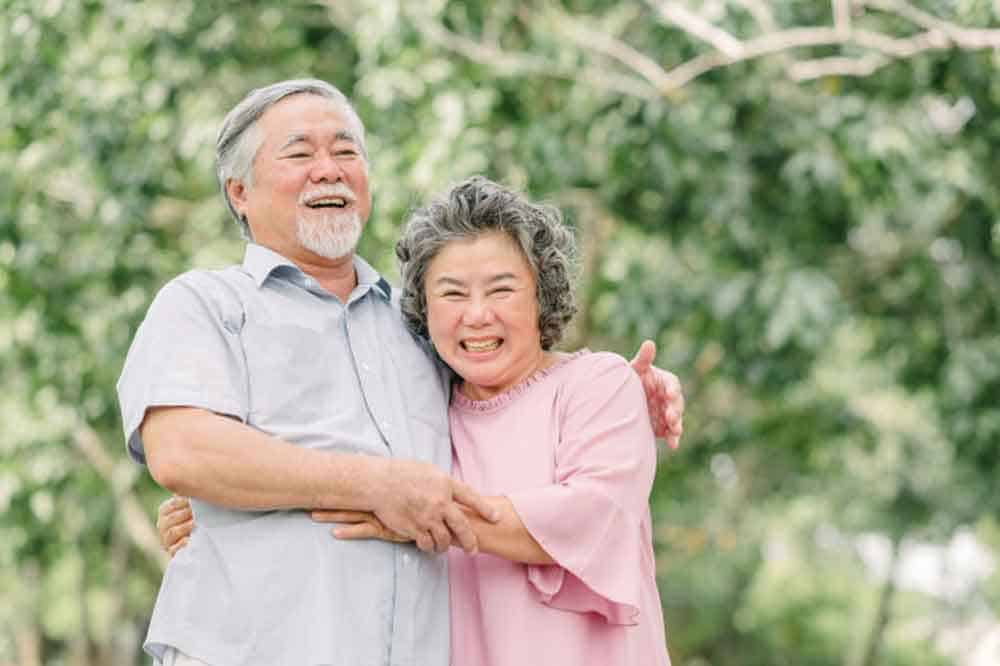 couple hugging in park smiling