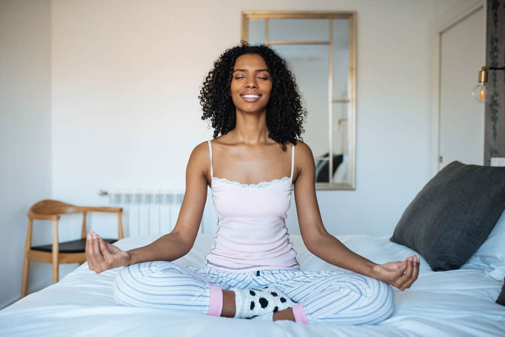 attractive-black-woman-bed-meditating
