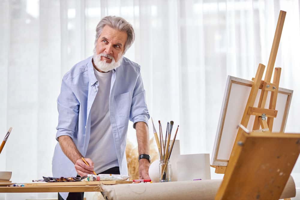artist-during-work-stand-contemplation-thinking-while-drawing-using-tools-painting